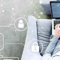 Cloud Computing with man using a laptop in a modern gray chair
